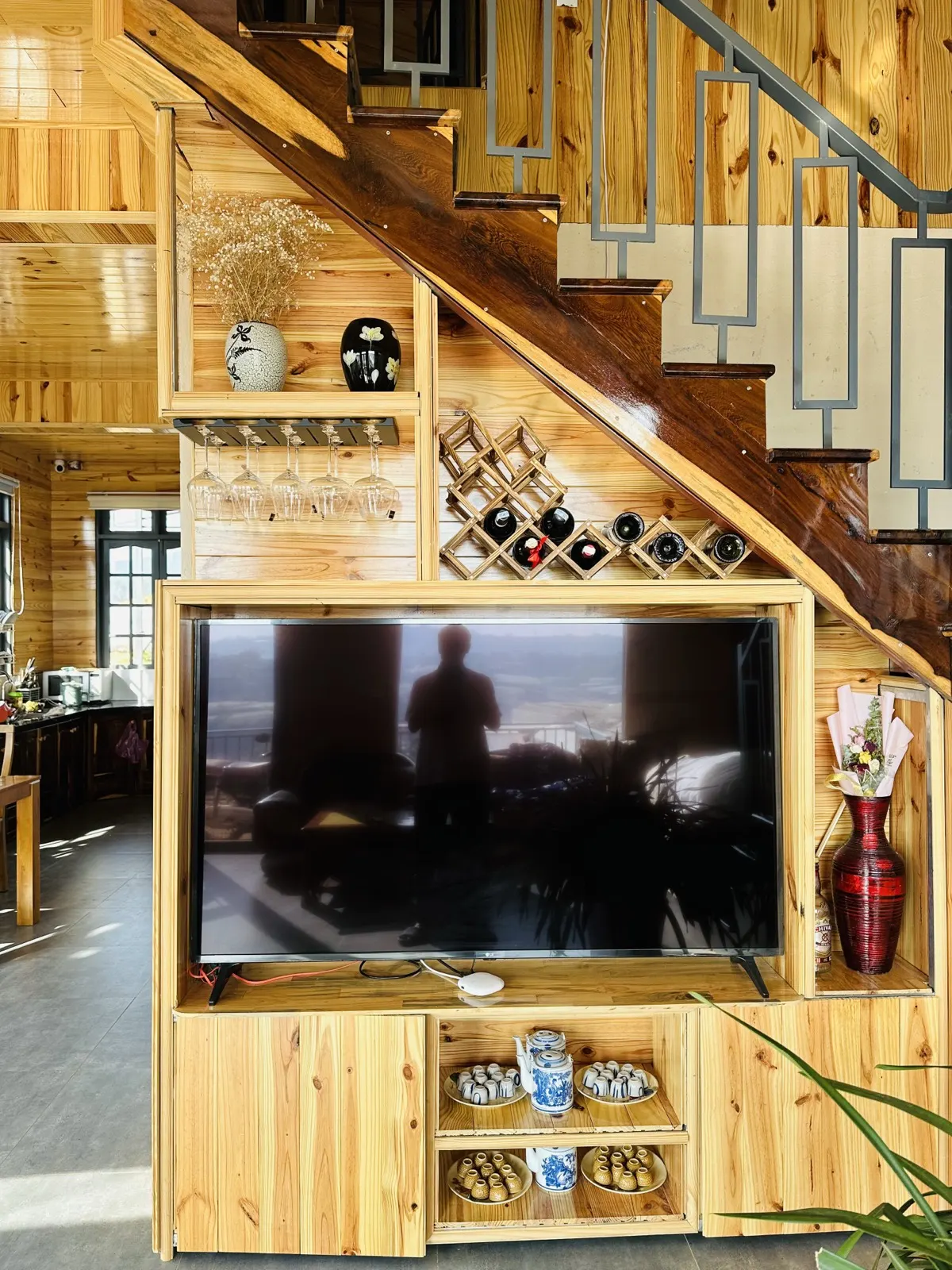 Phòng khách với TV và kệ gỗ thông